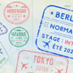 A passport stamped with different entry stamps, including one for Berlitz Normandie.